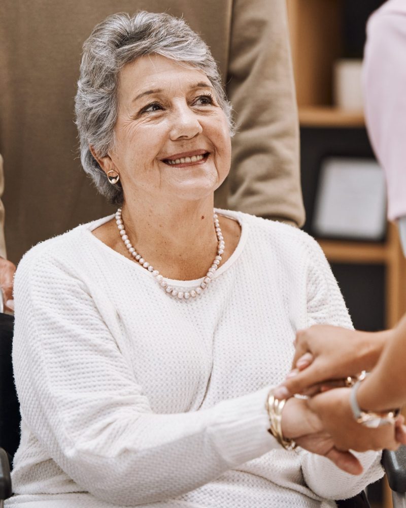 Disability, healthcare and nursing home with a senior woman patient in a wheelchair while talking t.